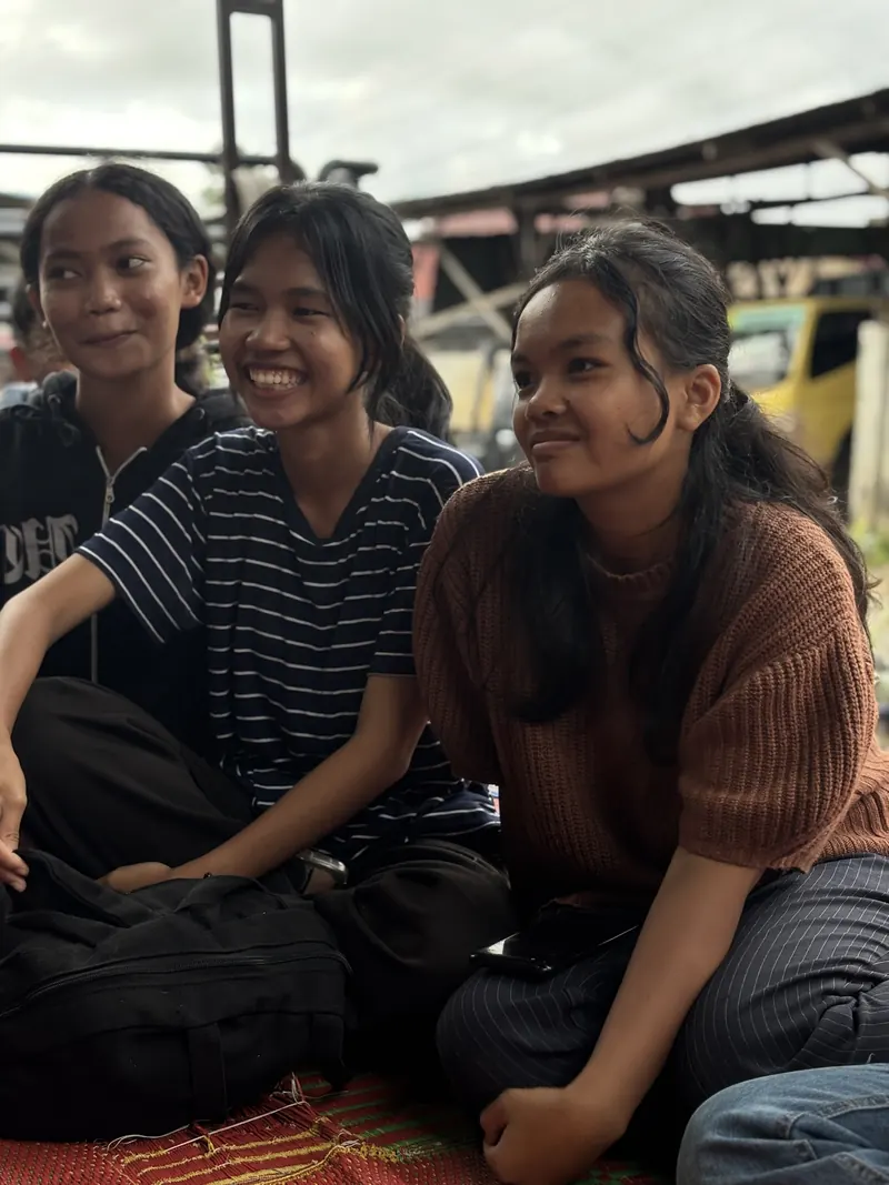 Three young women smiling together
